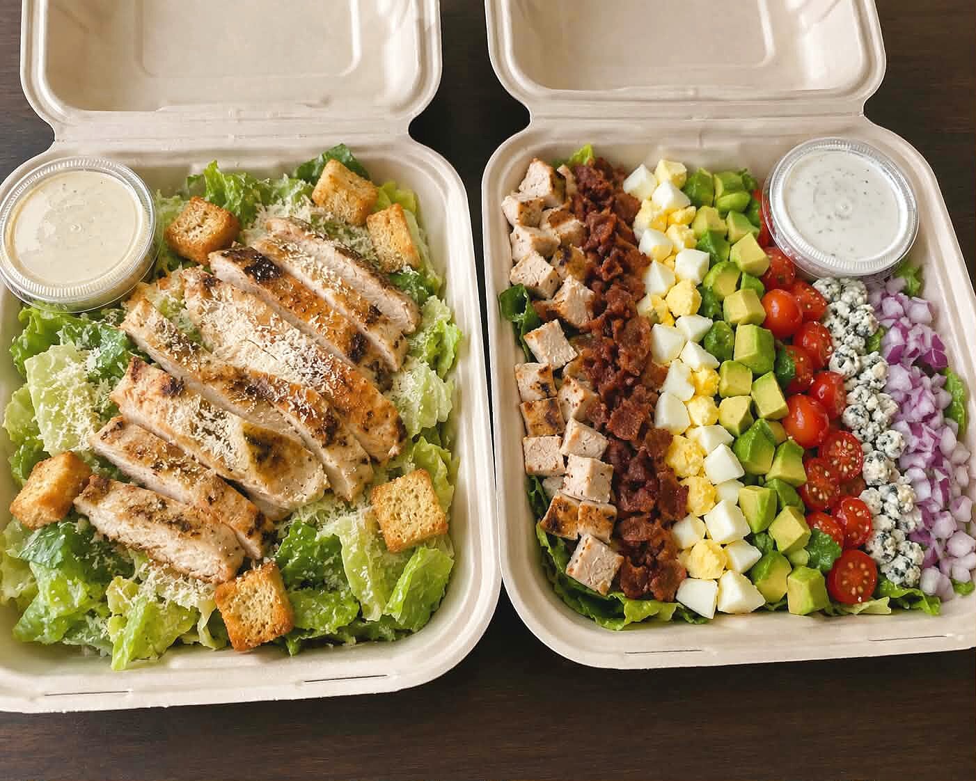 Chicken Caesar and Cobb salads in to-go boxes